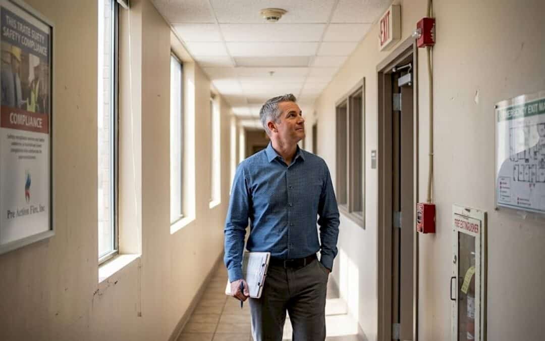 Building manager inspects fire safety system