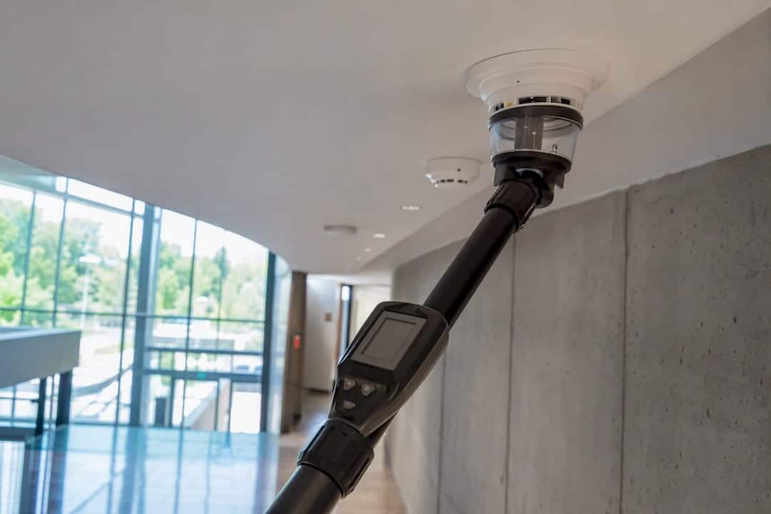 Fire alarm testing device near smoke detector