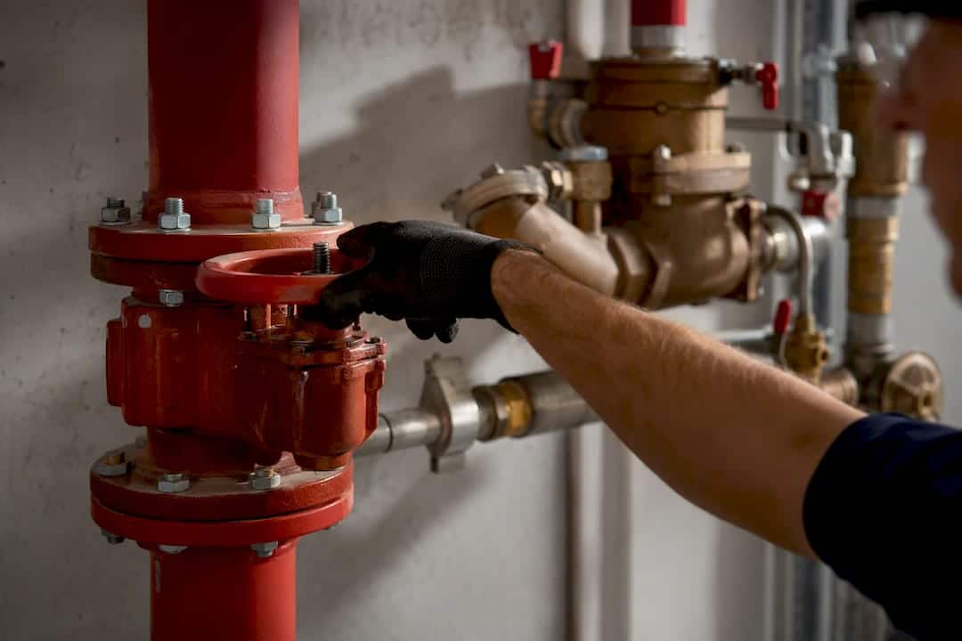 Technician isolating sprinkler test piping